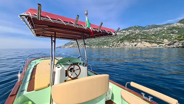 A striking front-angle view of the traditional Gozzo Sorrentino boat Bellavita showcasing its classic bow hull design in the sea near Maiori beach.